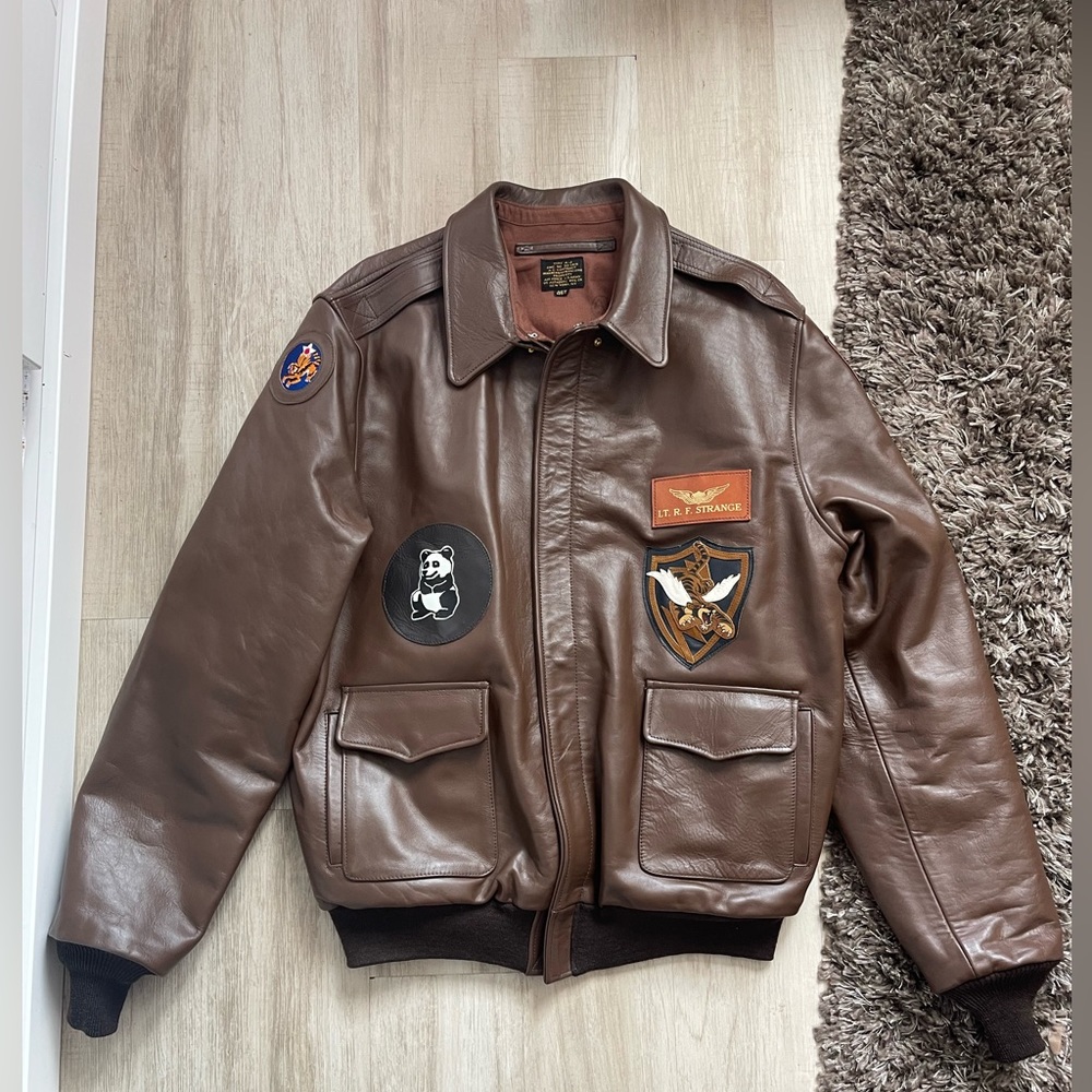 Vintage-Inspired Brown Leather Bomber Jacket with Patch Accents